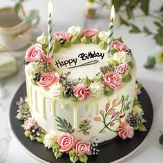 a birthday cake decorated with flowers and candles