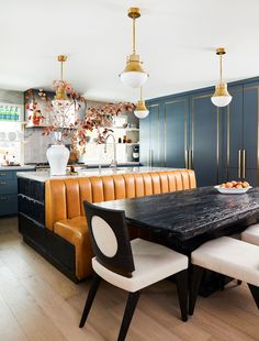 a kitchen with blue cabinets and white chairs