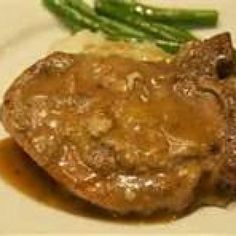 steak with gravy and asparagus on a white plate