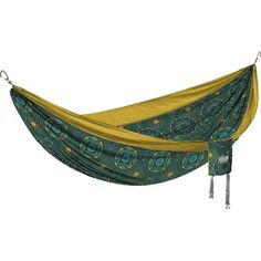 a green and yellow hammock hanging from a metal hook on a white background