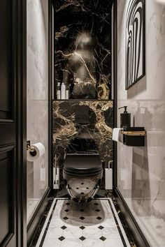 a black and white bathroom with marble floors, walls and flooring that has an art deco design on the wall