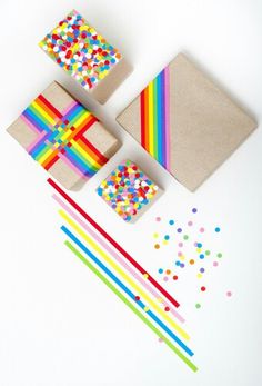 colorful paper and craft supplies laid out on a white surface with confetti sprinkles