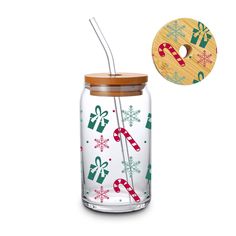 a glass jar with a wooden lid filled with candy canes and christmas themed items