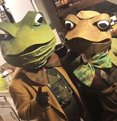 two people in frog costumes standing next to each other