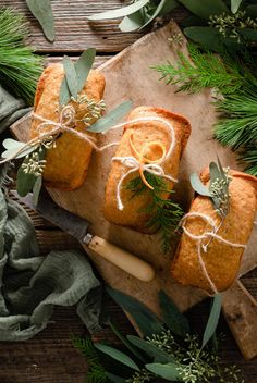 two slices of bread tied with twine and surrounded by greenery on a cutting board