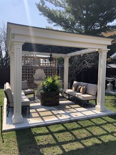 an outdoor living area with couches, chairs and a pergolated gazebo