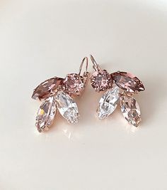 Gorgeous pair of earrings featuring Swarovski crystals in a lovely shades of morganite pink, light Burgundy and sparkling clear. Shown in the rose gold metal finish. Also available in gold or silver. Size: 1 1/2 inches long, 1 inch wide Thanks for stopping by. Pink Sparkling Crystal Earrings For Wedding, Pink Crystal Earrings With Sparkling Stones For Wedding, Wedding Pink Sparkling Crystal Earrings, Pink Sparkling Stones Crystal Earrings For Wedding, Mauve Earrings, Wedding Drop Earrings, Light Burgundy, Morganite Earrings, Special Occasion Jewelry