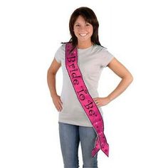 a woman standing with her hands on her hips wearing a pink sash that says bridge to go