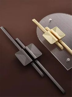 two chopsticks are placed next to a plate with food on it, and one is cut in half