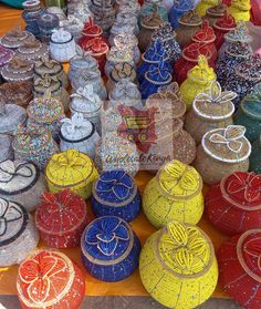 many different colored vases on display for sale