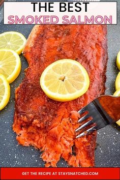 the best smoked salmon recipe with lemons on it and a fork stuck into it