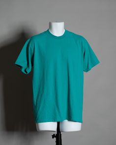 90s 00s plain tshirt in a turquoise blue color. GILDAN size - M vintage pre-owned cotton/polyester Turquoise Tshirt Outfit, Casual Turquoise Crew Neck T-shirt, Turquoise Cotton Crew Neck T-shirt, Turquoise Cotton Short Sleeve T-shirt, 90s Green Cotton T-shirt, 90s Style Green Cotton T-shirt, Turquoise Blue Outfit, Talk Poster, Turquoise Tshirt