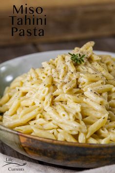 a bowl filled with pasta on top of a table