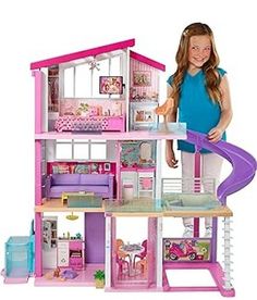 a girl is playing with her doll house