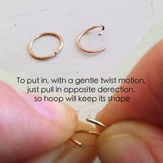 a person is holding two small gold hoops in their hand with the caption to put in, with a gentle twist motion, just pull in opposite direction so loop will keep its shape