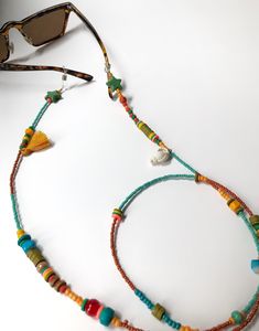 Handmade Beaded Glasses Chain,Seashell Sunglasses Strap, Eye Glass Holder,Boho Hippie Mask Chain,Summer Jewelry,Miyuki Seed Beads Lanyards If you are tired of playing hide and seek with your glasses and masks, there is a colorful news for you! Thanks to our handmade eyeglass straps, which make it almost impossible to lose glasses and give life to boring frames, you can wear your glasses comfortably by hanging them on your neck when not wearing them. It completes your full BOHO chic look! You can Glasses Strap Diy, Seashell Sunglasses, Summer Jewelry Beach, Eye Glass Holder, Diy Jewelry Videos, Beaded Glasses Chain, Beaded Glasses, Eyeglass Strap, Glasses Strap