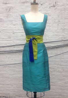 "Classic and elegant squared scoopneck fitted silk shantung dress. Shown in a brilliant Ocean Blue turquoise shantung with contrasting chartreuse green lining and optional obi sash (sold separately-link below). https://www.etsy.com/listing/114716566/turquoise-chartreuse-reversible-silk?ref=shop_home_active_9 -fitted sheath dress with empire seam and princess seams -slightly tapered skirt hits just below-the-knee -center back vent (or optional side slits) -invisible center back zipper -silk shant Silk Dresses With Sashes, Silk Shantung Dress, Shantung Silk Dress, Shantung Dress, Silk Dresses Outfit, Tapered Skirt, Obi Sash, Thai Silk Dresses, Shantung Silk