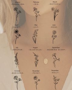 a woman's neck with flowers and names written on the back of her necklace