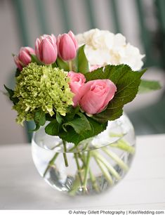 a vase filled with pink and white flowers