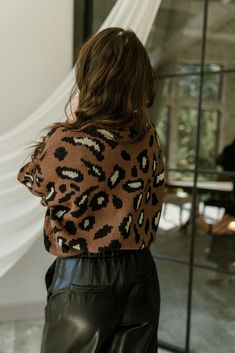 The Isla Brown & Black Cheetah Sweater is a cozy yet stylish piece that adds a touch of wild sophistication to your wardrobe. Made from soft brown knit fabric, this sweater features an eye-catching leopard print that brings a playful flair to any outfit. The ribbed hem ensures a snug fit, while the round neckline offers a classic silhouette. With long balloon sleeves that provide a relaxed and trendy look, the Isla sweater is perfect for layering or wearing on its own. Pair it with your favorite