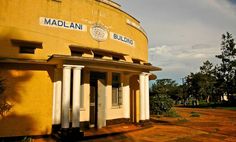 an old building with columns in front of it and the name madami on the side