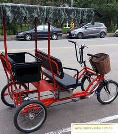 a red bike with two seats and a basket on the back is parked in a parking lot