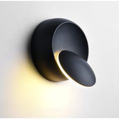 a black wall light with two lights on it