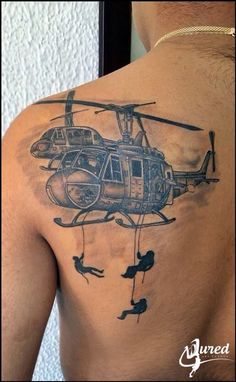 a man with a helicopter tattoo on his back