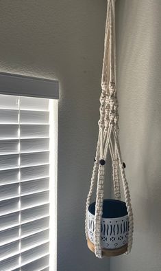 a hammock hanging from the side of a wall next to a window with shutters