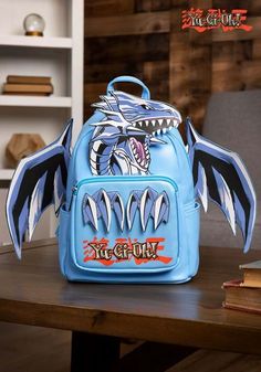 a blue backpack sitting on top of a wooden table next to a book case and bookshelf