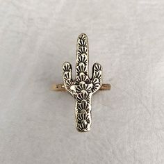 "Listing for one ring. Saguaro cactus ring, hand carved design, cast in the Heliotrope studio. Choose solid sterling silver ($54), or solid brass ($44) at checkout. Select your size at checkout. Saguaro measures approximately 1.25\" tall x .5\" wide. Check out our other listings for MATCHING earrings and necklace: https://www.etsy.com/listing/579322655/spiny-saguaro-necklace-silver-or-brass? https://www.etsy.com/listing/552978260/spiny-saguaro-studs-cactus-earrings?ref=shop_home_feat_4" Cactus Ring, Silversmithing Jewelry, Brass Rings, Cactus Earrings, Cowgirl Jewelry, Hammered Band, Saguaro Cactus, Western Jewelry, Brass Gold