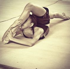 a woman is doing yoga on the floor