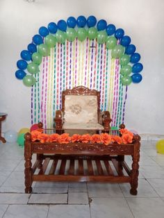 a chair sitting in front of a balloon arch