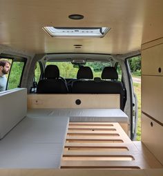 the interior of a van with two people in it