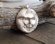 This celestial sun and moon pendant necklace is made by using the ancient lost wax technique and it is hand forged. It comes in a sterling silver chain of your choice or a wax cord and the pendant is 23gr solid sterling silver made in great detail. A unique, ethereal piece of jewelry that will add character to any look and is ideal as a gift to yourself or to someone special. The total length of the chain is 460mm, please contact me if you would like me to custom made the length of your chain. A Hand Forged Sterling Silver Celestial Necklace, Celestial Sun And Moon Sterling Silver Necklace, Sterling Silver Necklace With Sun Design, Silver Sterling Silver Necklace With Sun Design, Silver Celestial Necklace With Sun Design, Celestial Sterling Silver Necklace With Sun Design, Bohemian Hand Cast Sterling Silver Necklace, Hand Forged Silver Celestial Jewelry, Unique Sterling Silver Sun And Moon Jewelry