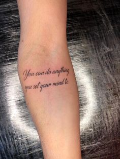 a person with a tattoo saying you can do anything you set your mind to