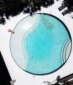 a woman laying on the edge of a swimming pool