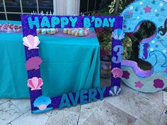 a table topped with cupcakes and cake next to a sign that says happy birthday