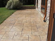 a stone walkway in front of a brick building