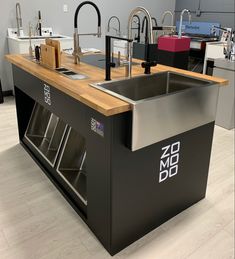 a kitchen island with two sinks and an oven