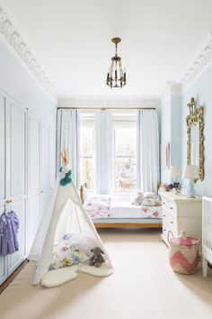 a child's bedroom with a teepee tent in the corner