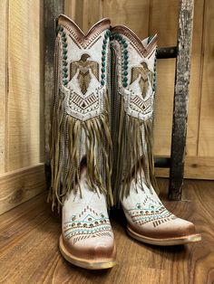 Irresistible, stunning, and flirty. This Corral Women's beige boot is a great choice for a fun night or an every day edgy style sure to catch everyones eye. This 14-inch shaft with its fun chain and leather fringe, turquoise studs, tan embroidery, and crystals will have you turning everyones head to admire them.You can wear this style all day without worrying about getting tired. It features; sturdy pull-on straps and an elegant snip toe. The smooth inside leather lining, cushioned leather insole, leather outer sole with a rubber insert and rubber heel cap, and 2 1/2 -inch stacked heel, scream comfort. Lightly cushioned footbed Fun chain and leather fringe Crystal Accents 14" shaft Snip toe 15" calf circumference 2.75" heel Vamp: Cowhide Cowboy Heel Leather Sole Snip Toe Cowgirl Boots, Western Boots For Women, Turquoise Crystals, Cowgirl Boots Outfit, Bota Country, Beige Boots, Western Store, Custom Boots, Turquoise Crystal