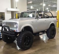 a white truck parked inside of a garage