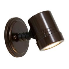 an outdoor wall light that is on the side of a white wall and has a dark brown finish