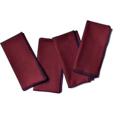 four pieces of red cloth folded on top of each other with purple piping around the edges