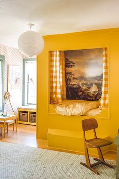 a living room with yellow walls and furniture