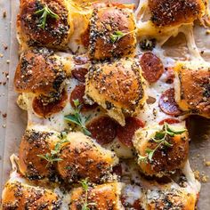 pepperoni and cheese sliders on a sheet of parchment paper with sprinkles