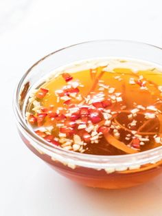 a glass bowl filled with food on top of a table