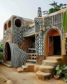 an artisticly designed building with stairs and potted plants