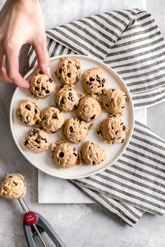 chocolate chip cookies on a white plate with utensils